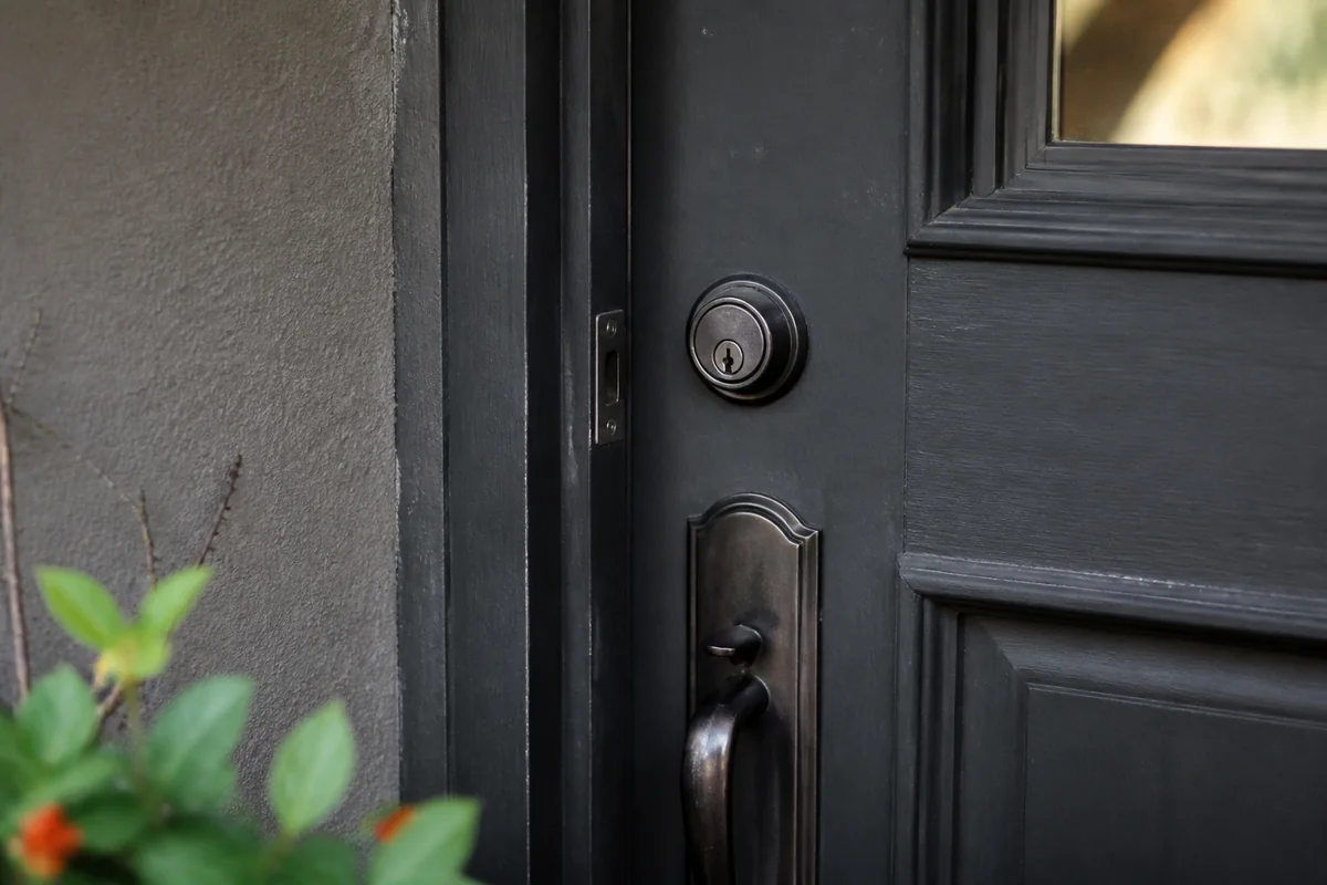 Residential door latch and deadbolt in a clean daylight hardware detail.
