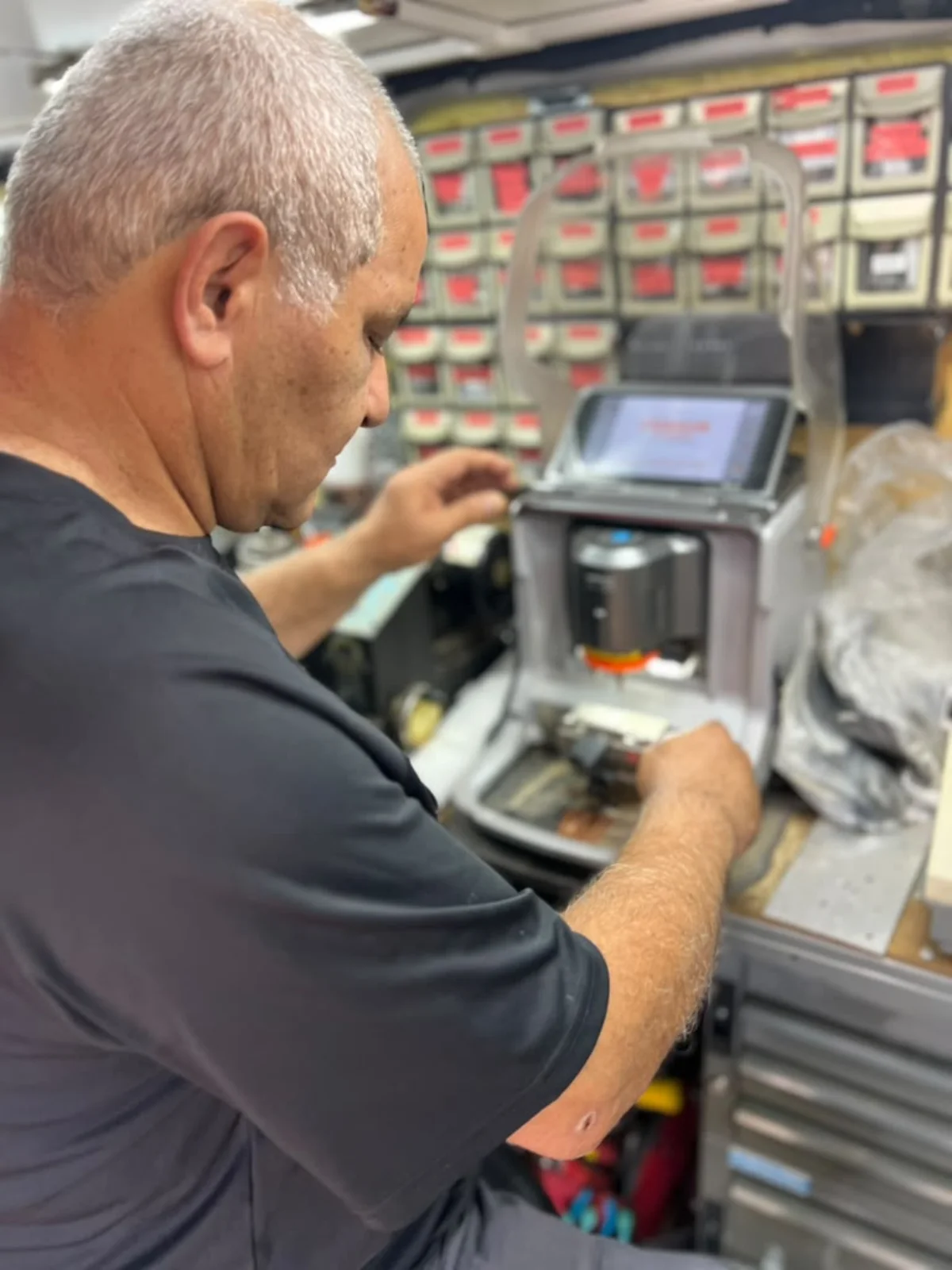 Hi-Q Locksmith owner Isaac cutting a duplicate key inside the Fort Worth mobile workshop.