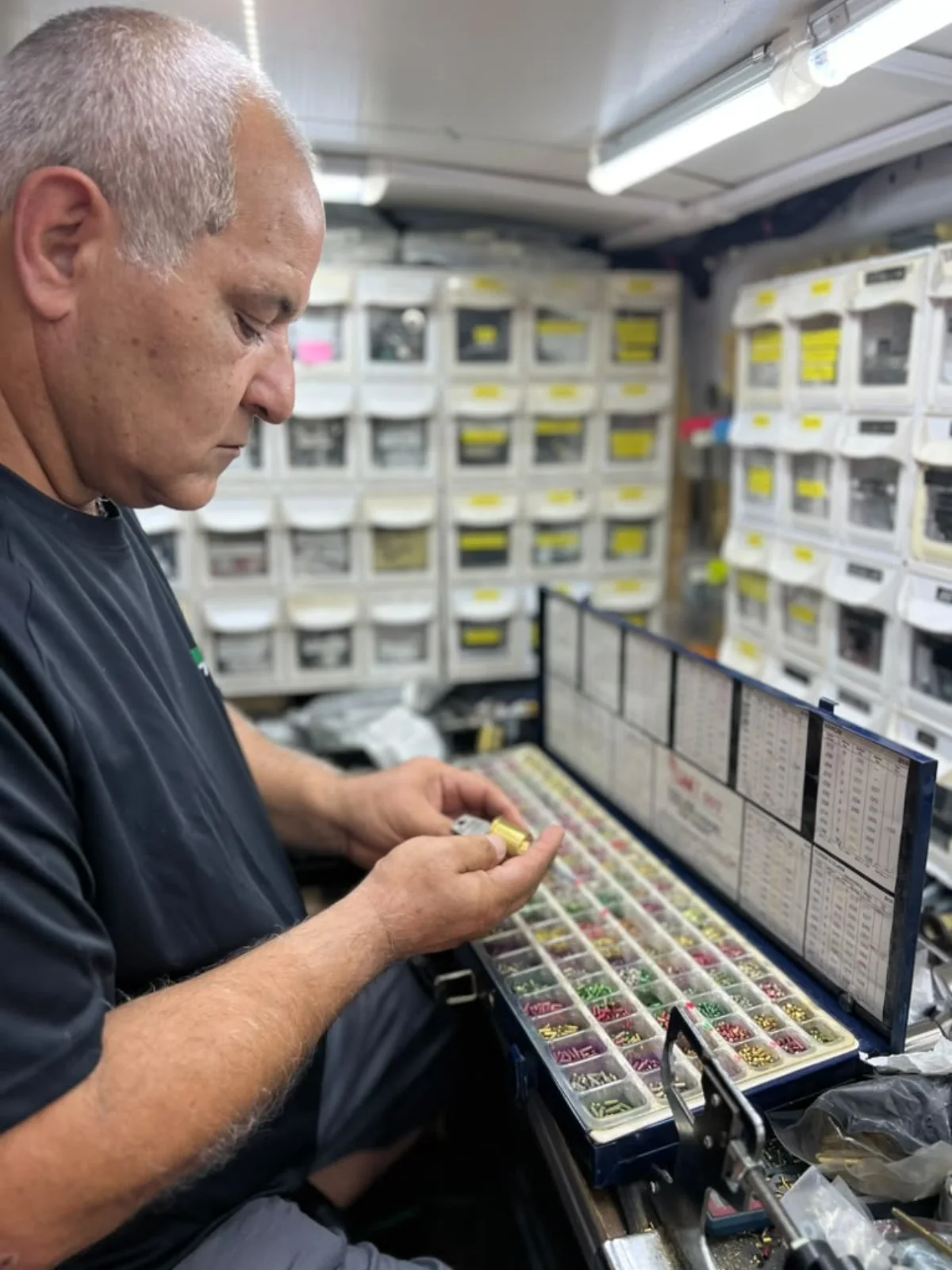 Hi-Q Locksmith owner Isaac rekeying a lock cylinder inside the mobile workshop in Fort Worth, Texas.