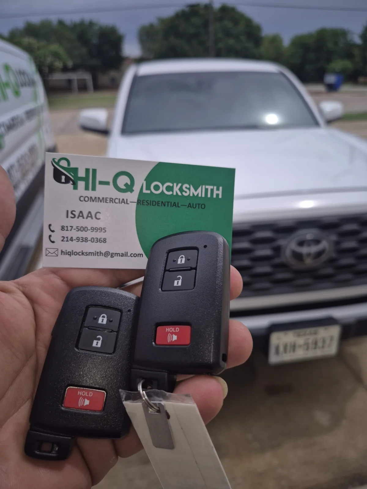 Two completed Toyota key fobs with a Hi-Q Locksmith business card at a Fort Worth automotive service call.